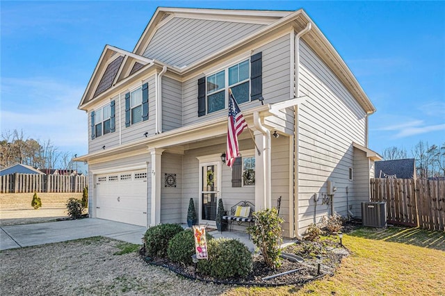 view of front of property with a garage, driveway, fence, and cooling unit