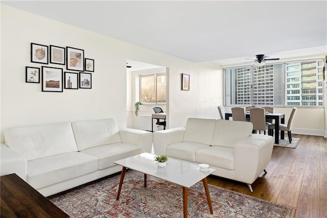 living room featuring ceiling fan and wood-type flooring