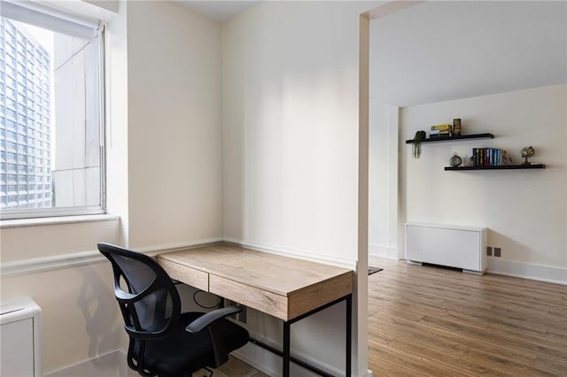 home office with hardwood / wood-style flooring