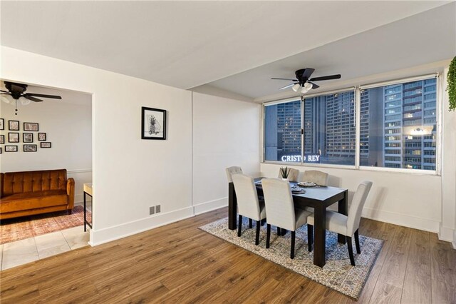 dining space featuring ceiling fan and hardwood / wood-style flooring