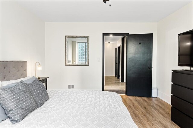 bedroom with light wood-type flooring