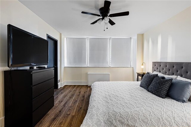 bedroom with ceiling fan and dark hardwood / wood-style floors