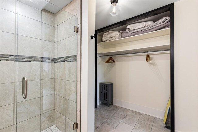 bathroom with tile patterned floors and a shower with shower door