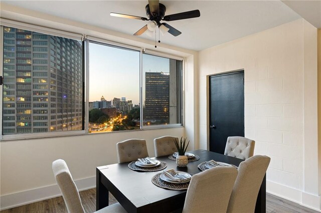 dining area with ceiling fan, hardwood / wood-style floors, and a healthy amount of sunlight