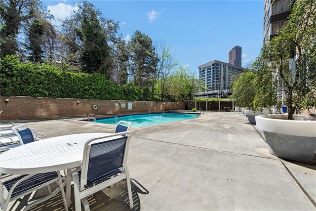 view of swimming pool featuring a patio