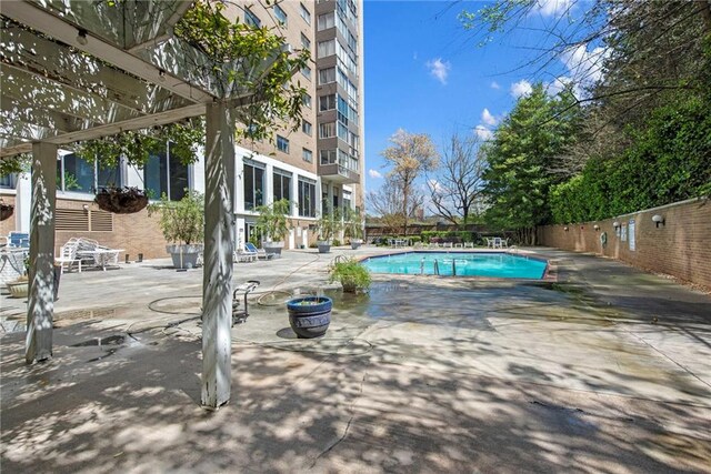 view of pool with a pergola and a patio area