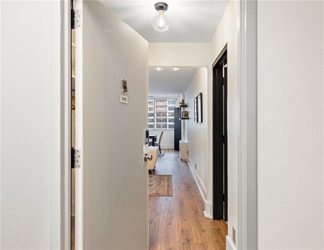 corridor featuring light hardwood / wood-style floors