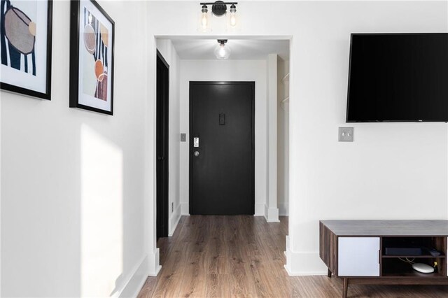 hallway featuring wood-type flooring