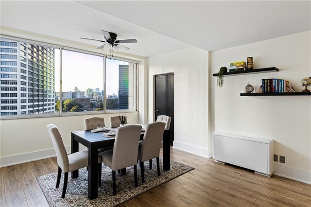 dining area featuring hardwood / wood-style flooring and ceiling fan