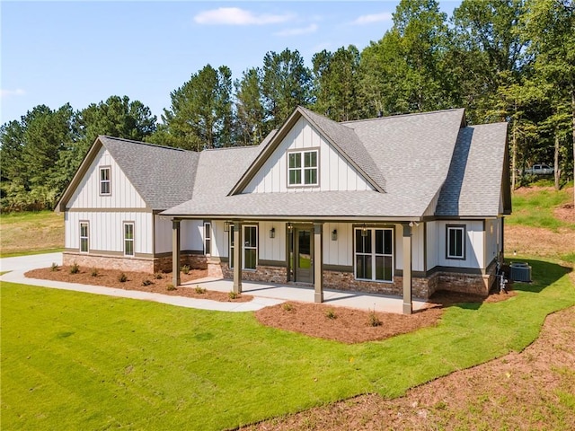 view of front of property featuring a porch, a front lawn, and central air condition unit