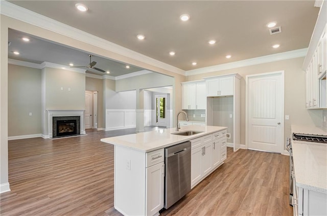 kitchen featuring a kitchen island with sink, sink, white cabinetry, and stainless steel appliances