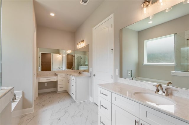 bathroom featuring vanity and independent shower and bath