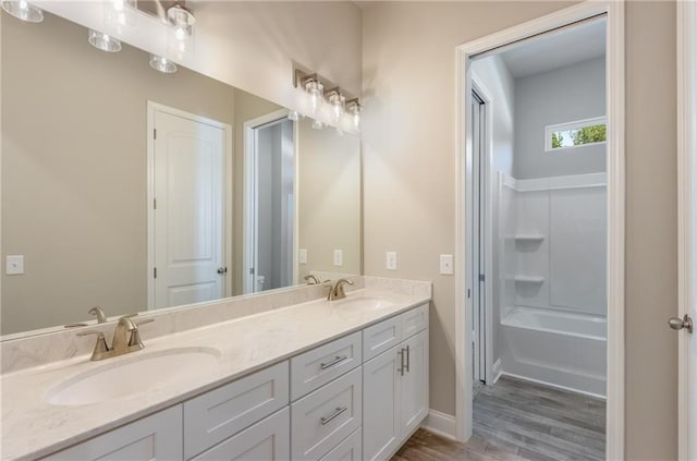 bathroom with vanity, wood-type flooring, and shower / bathing tub combination