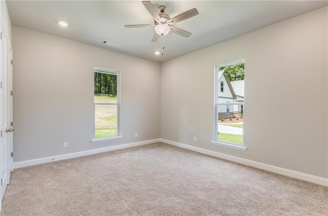 spare room with carpet floors and ceiling fan