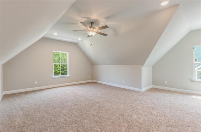 additional living space with vaulted ceiling, ceiling fan, and carpet floors