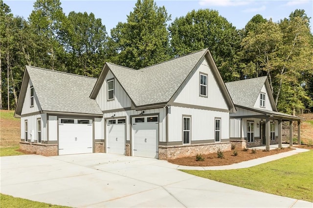 view of side of property with a porch, a garage, and a lawn