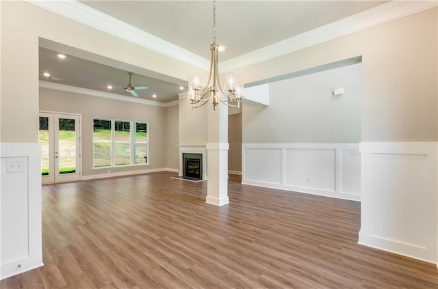 unfurnished living room with french doors, ornamental molding, wood-type flooring, and ceiling fan with notable chandelier