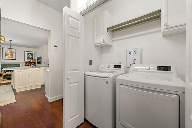 laundry area featuring cabinets, dark wood-type flooring, and independent washer and dryer