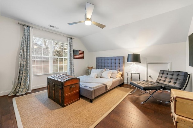 bedroom featuring dark wood-type flooring, vaulted ceiling, and ceiling fan