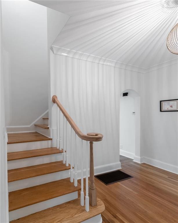 staircase featuring dark hardwood / wood-style flooring