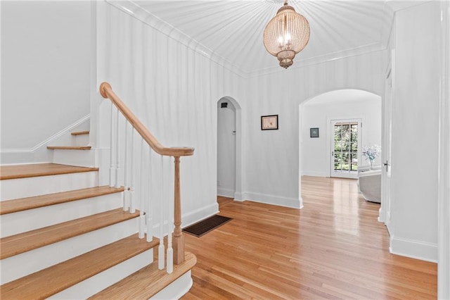 foyer featuring ornamental molding and light hardwood / wood-style floors