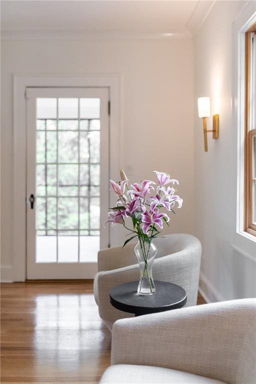 entryway featuring crown molding and light hardwood / wood-style flooring