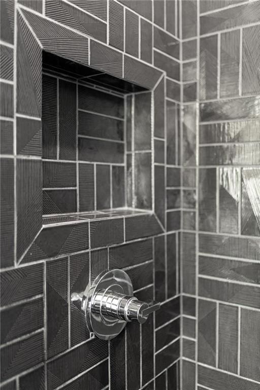 interior details featuring a tile shower