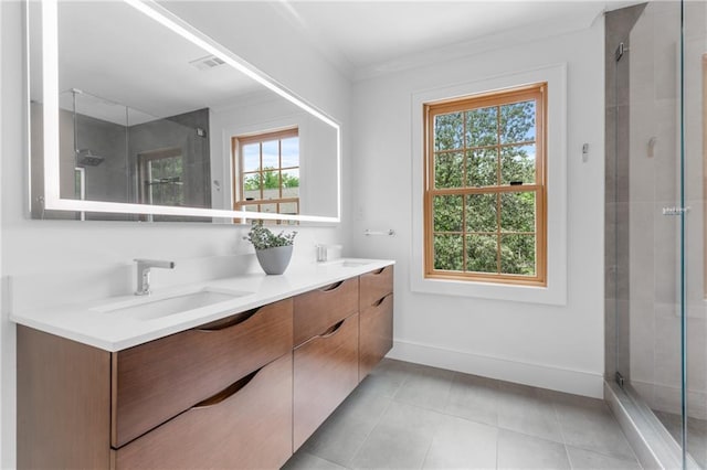 bathroom with double sink vanity, tile floors, ornamental molding, and a shower with shower door