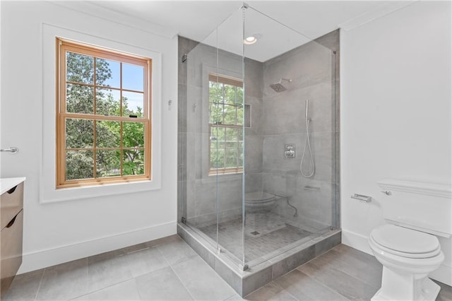 bathroom featuring walk in shower, toilet, vanity, and plenty of natural light