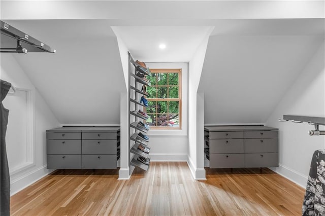 spacious closet with vaulted ceiling and light hardwood / wood-style floors