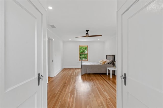 unfurnished bedroom with ceiling fan and light hardwood / wood-style floors