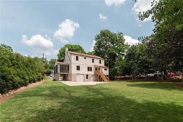 back of house with a deck, a patio area, and a yard