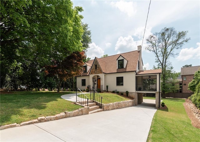 view of front of home with a front lawn and a sunroom