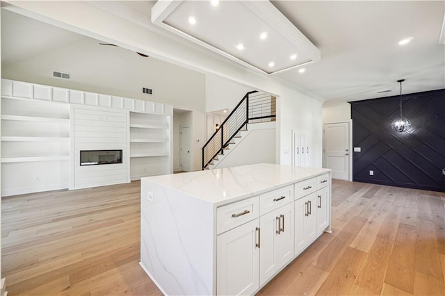 4815 Price Rd, Gainesville, GA 30506 - kitchen with white cabinets, light wood-style flooring, light stone countertops, a center island, and recessed lighting