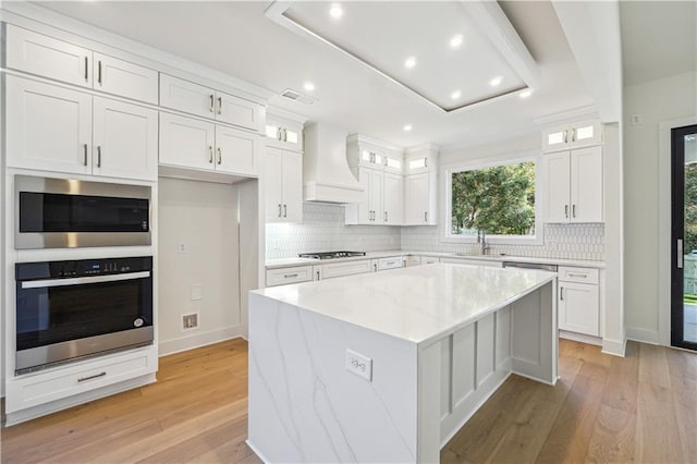 4815 Price Rd, Gainesville, GA 30506 - kitchen featuring appliances with stainless steel finishes, custom range hood, recessed lighting, a kitchen island, and white cabinetry