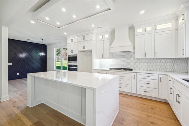 4815 Price Rd, Gainesville, GA 30506 - kitchen featuring appliances with stainless steel finishes, custom range hood, recessed lighting, a kitchen island, and white cabinetry