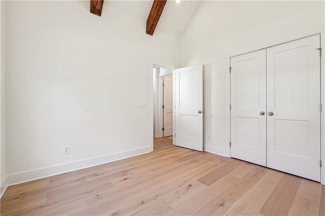 4815 Price Rd, Gainesville, GA 30506 - unfurnished living room featuring light wood finished floors, high vaulted ceiling, built in shelves, ceiling fan, and a large fireplace