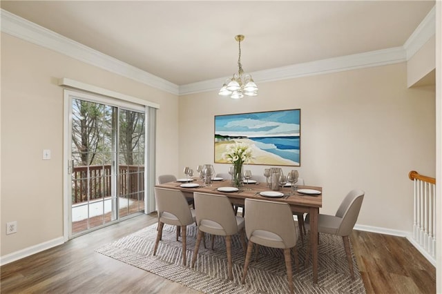 dining area with crown molding, baseboards, and wood finished floors