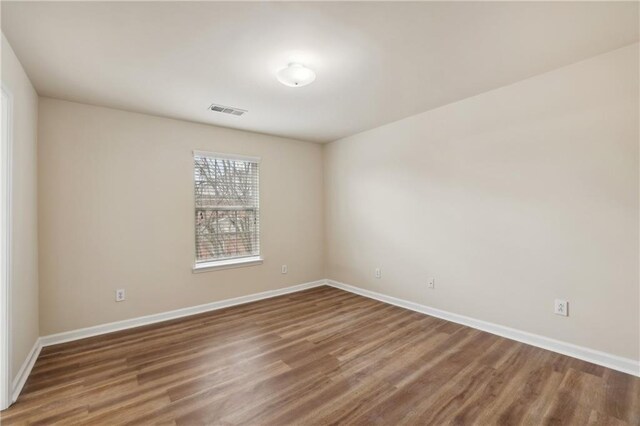 spare room featuring hardwood / wood-style flooring