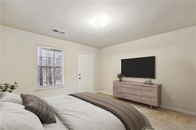 bedroom with visible vents, light colored carpet, and baseboards