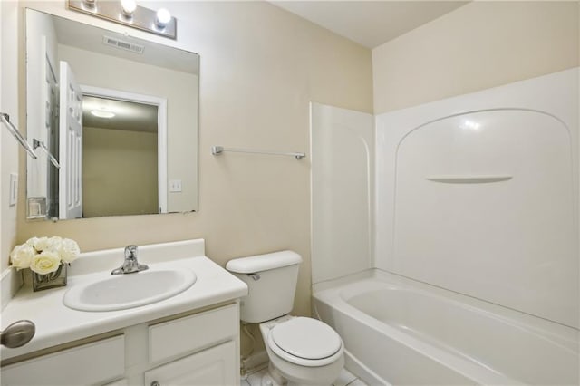 bathroom with vanity, toilet, and visible vents