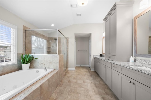 bathroom featuring lofted ceiling, visible vents, a shower stall, vanity, and a jetted tub