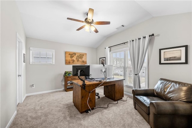 office featuring light carpet, visible vents, baseboards, a ceiling fan, and lofted ceiling