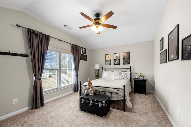 bedroom with lofted ceiling, baseboards, visible vents, and light colored carpet