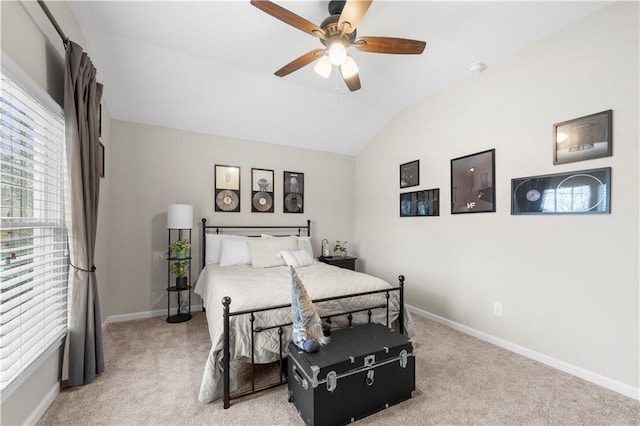 bedroom with vaulted ceiling, baseboards, a ceiling fan, and light colored carpet