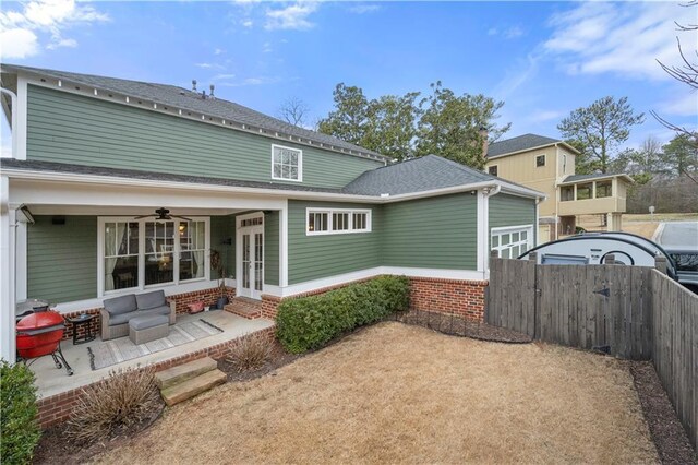 rear view of house with french doors, roof with shingles, entry steps, fence, and ceiling fan