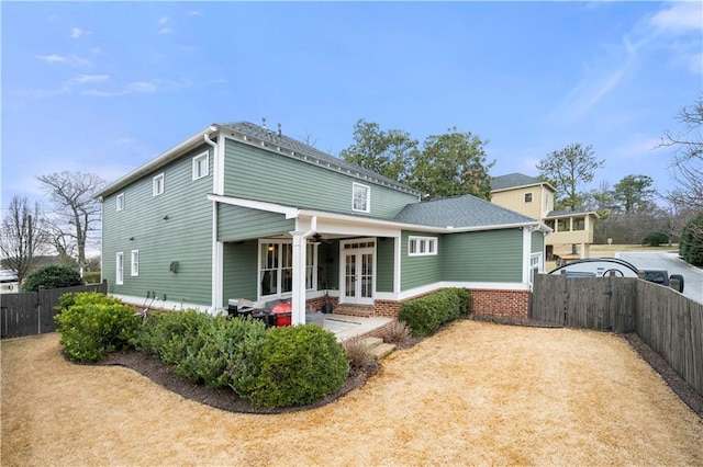 view of front of home featuring french doors, fence, and a gate