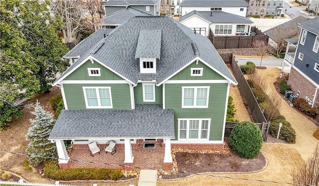 exterior space with roof with shingles and board and batten siding