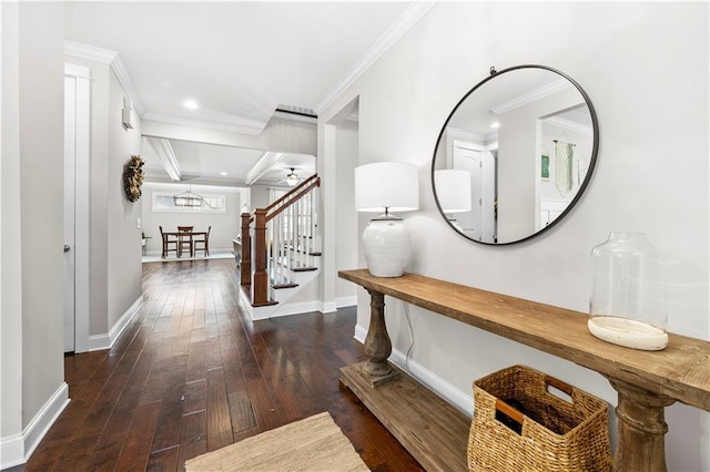 foyer entrance with baseboards, hardwood / wood-style floors, stairs, and crown molding