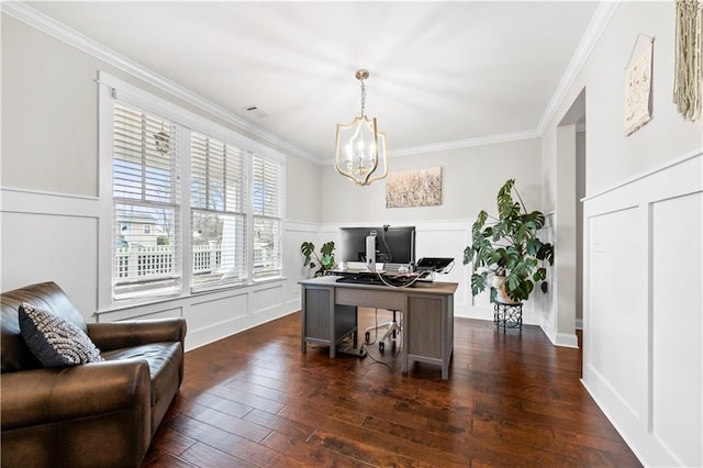 home office with dark wood-style floors, crown molding, a decorative wall, wainscoting, and a chandelier